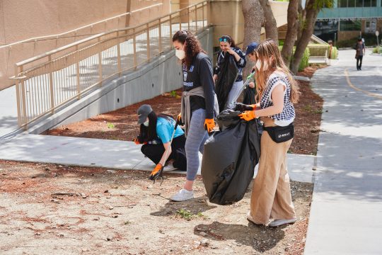 Students cleaning up trash on campus as part of Divers Against Debris 