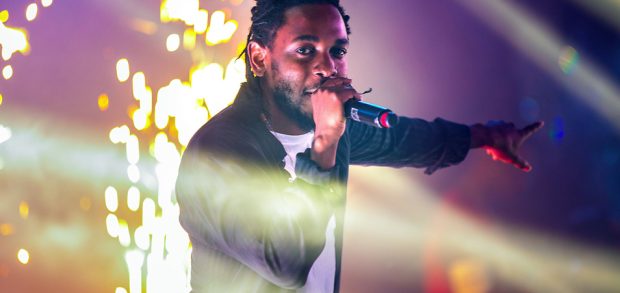Kendrick Lamar singing into a microphone. 