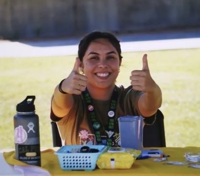 Marissa Lepe flashing a thumbs up while sitting at a BEAT event