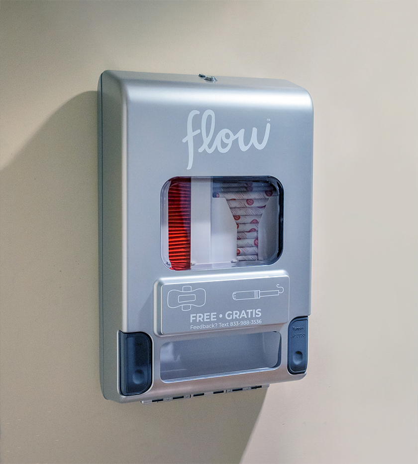 Flow menstrual product dispenser on a wall