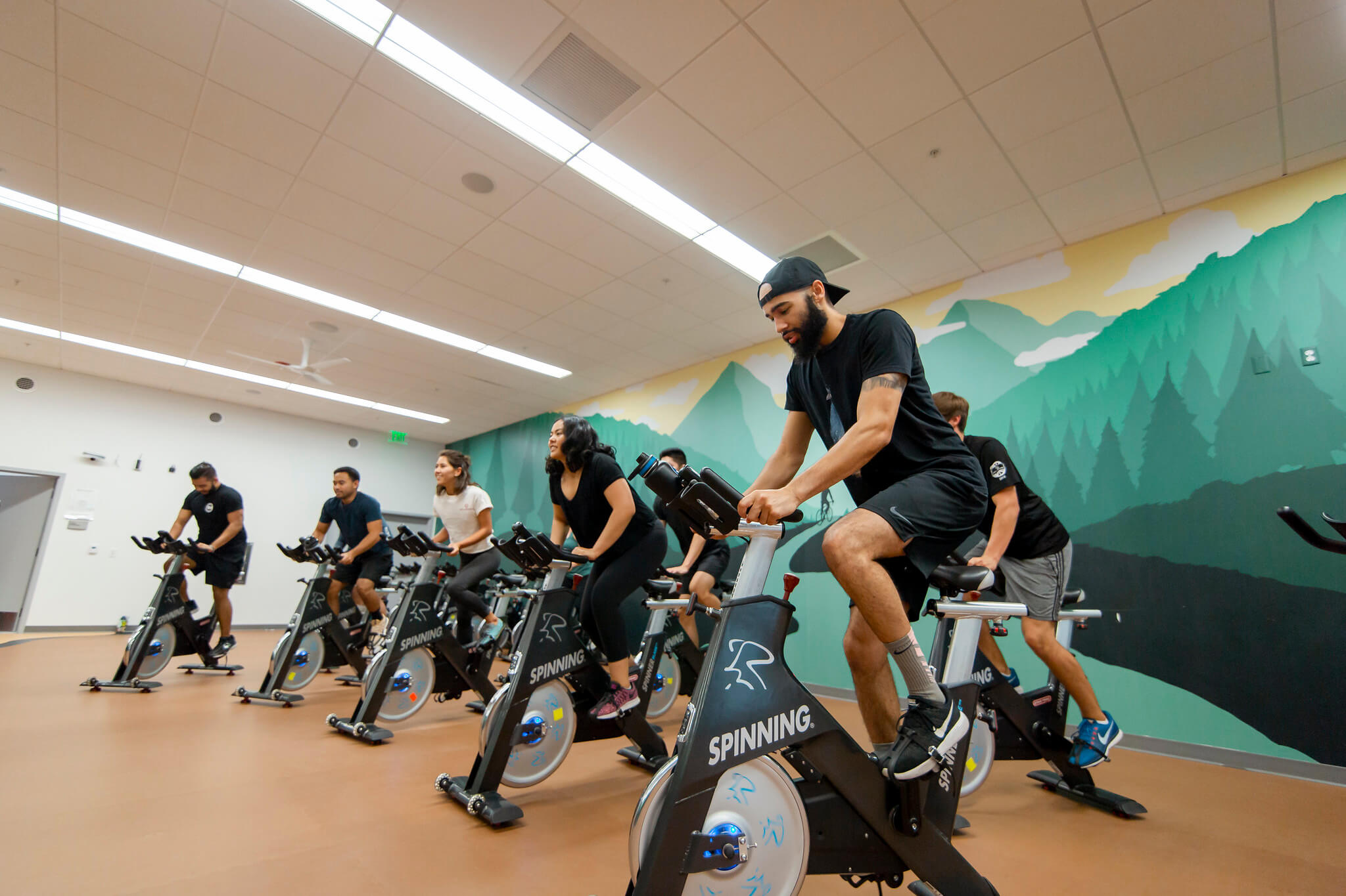 students riding stationary bikes together