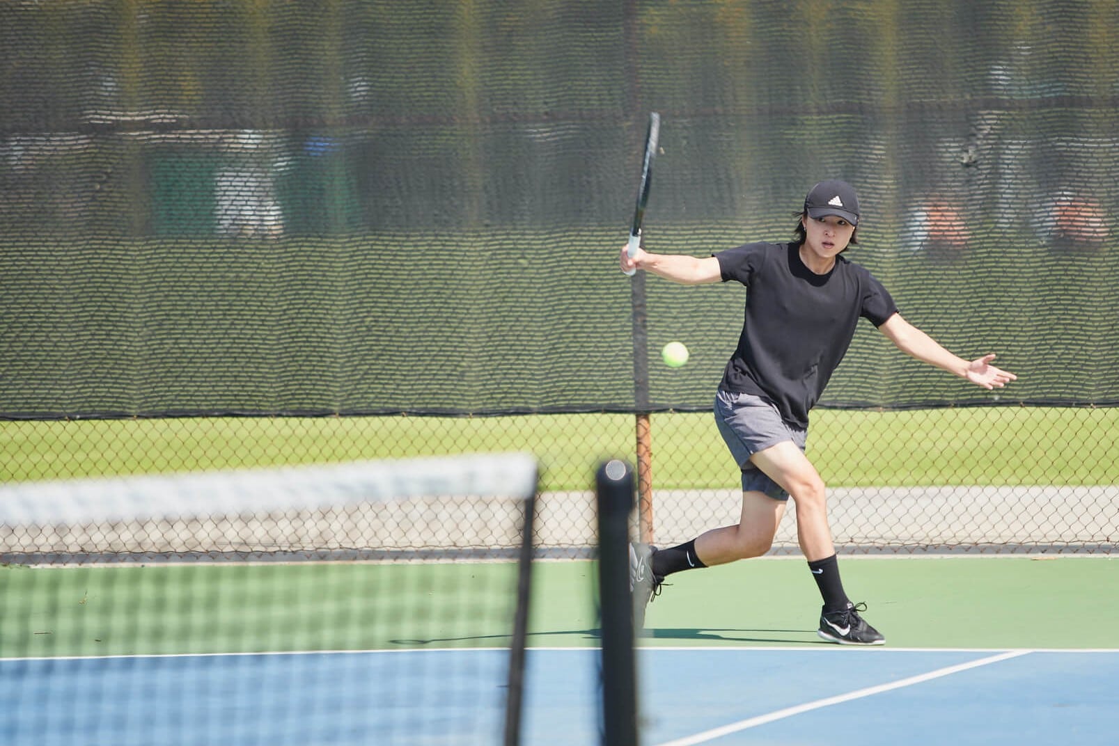 student playing tennis
