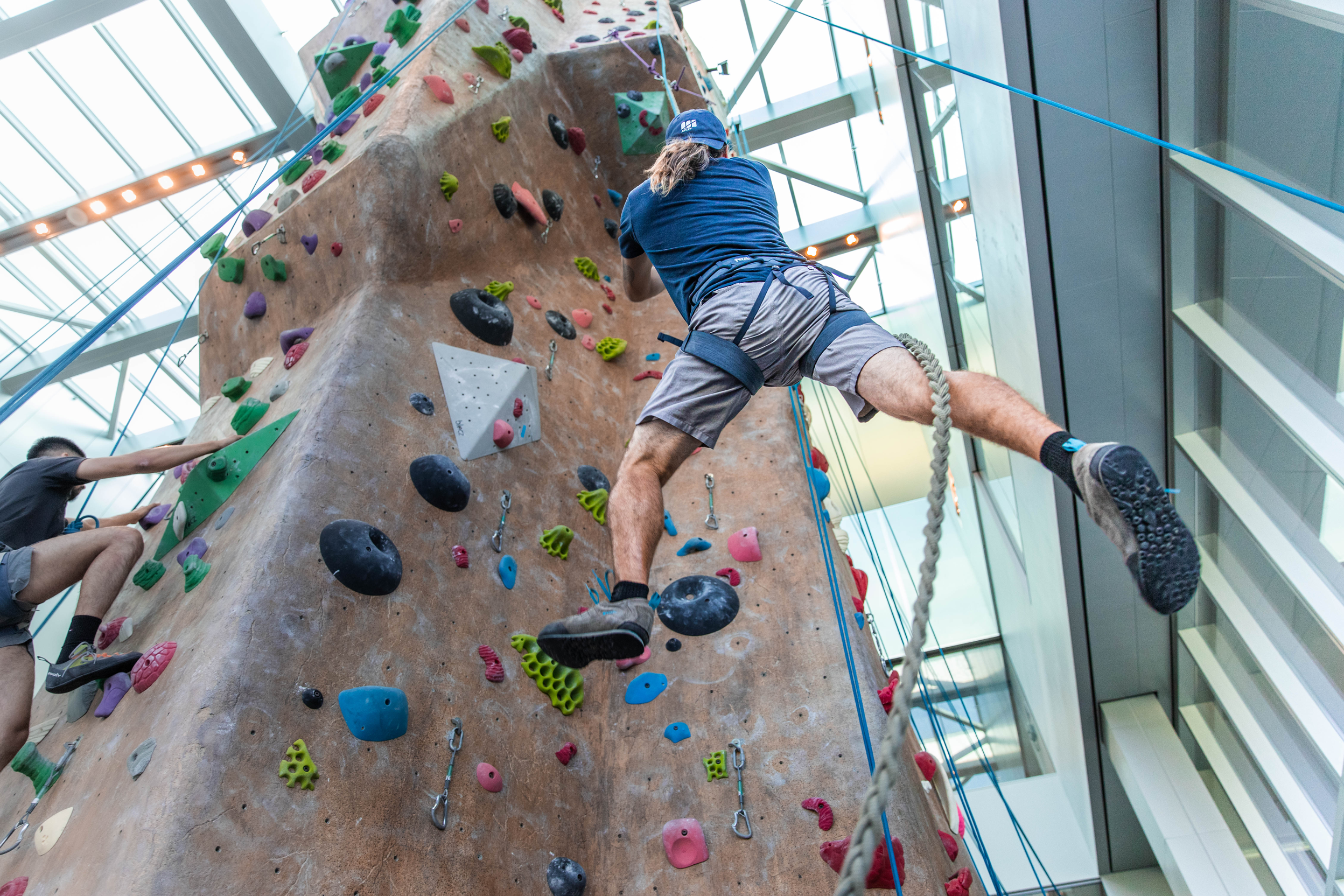 Climber being lowered from the rock climbing wall