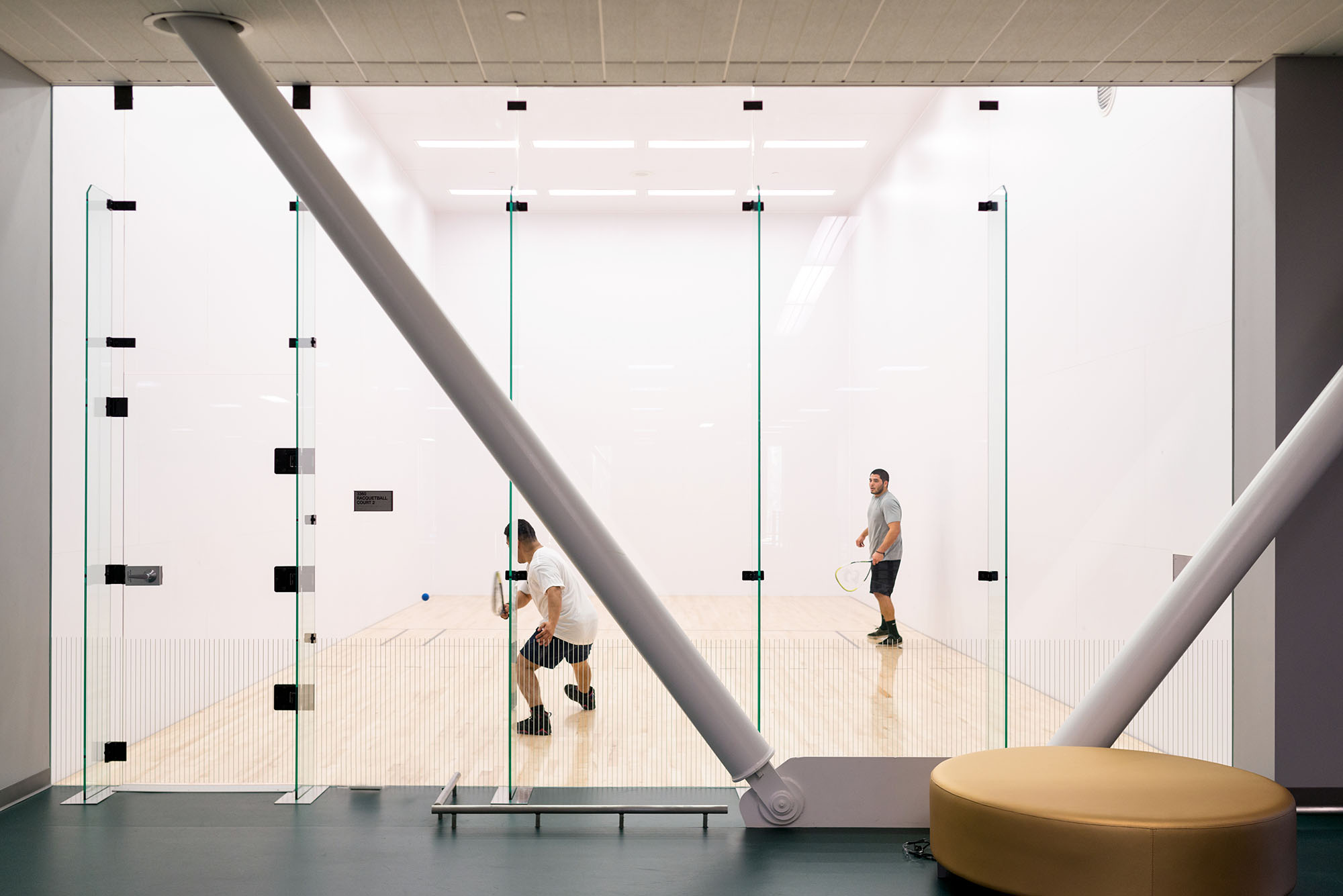 Two students playing in the racquetball court