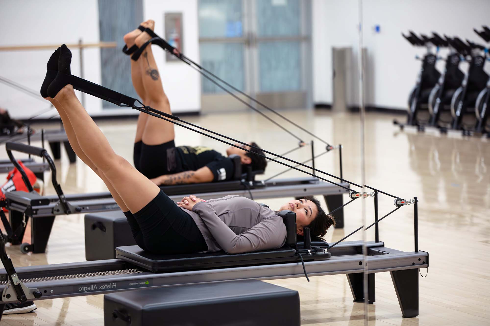 students exercising with pilates equipment