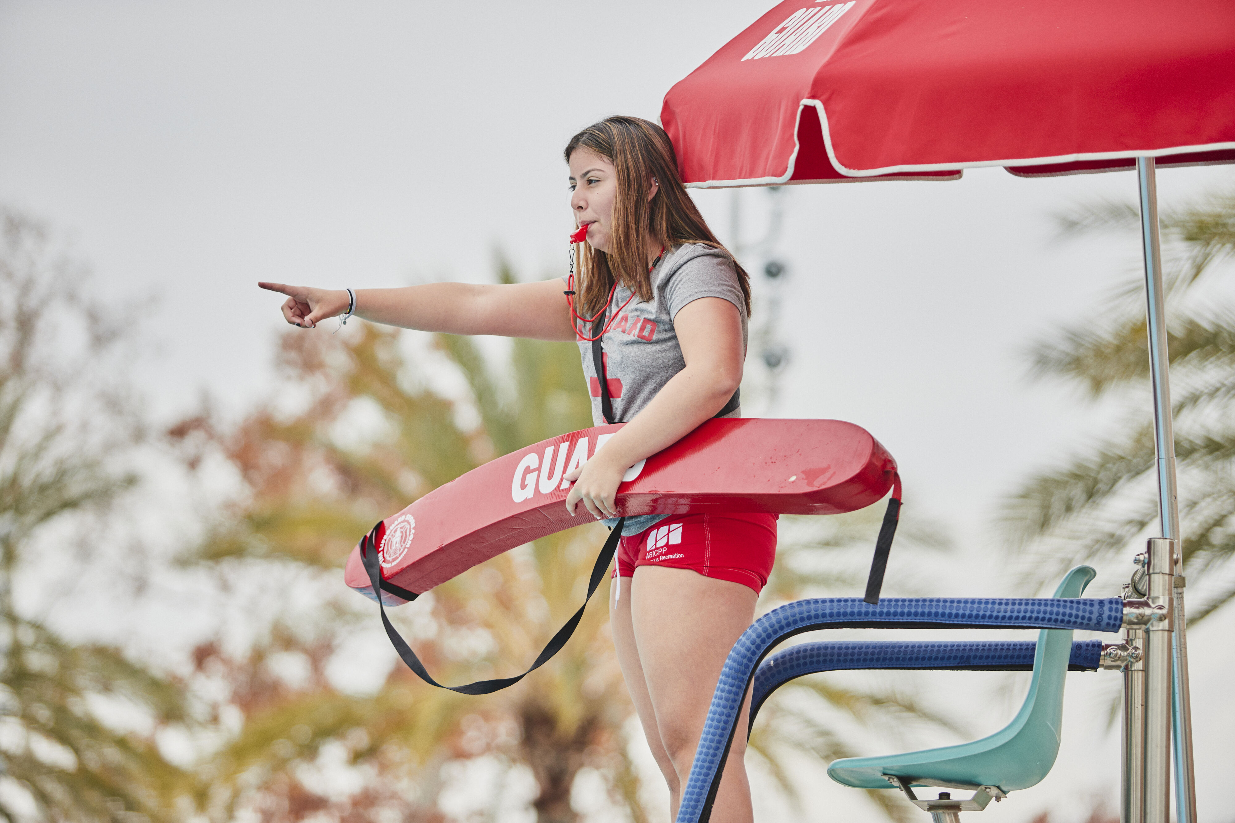 A lifeguard pointing at something