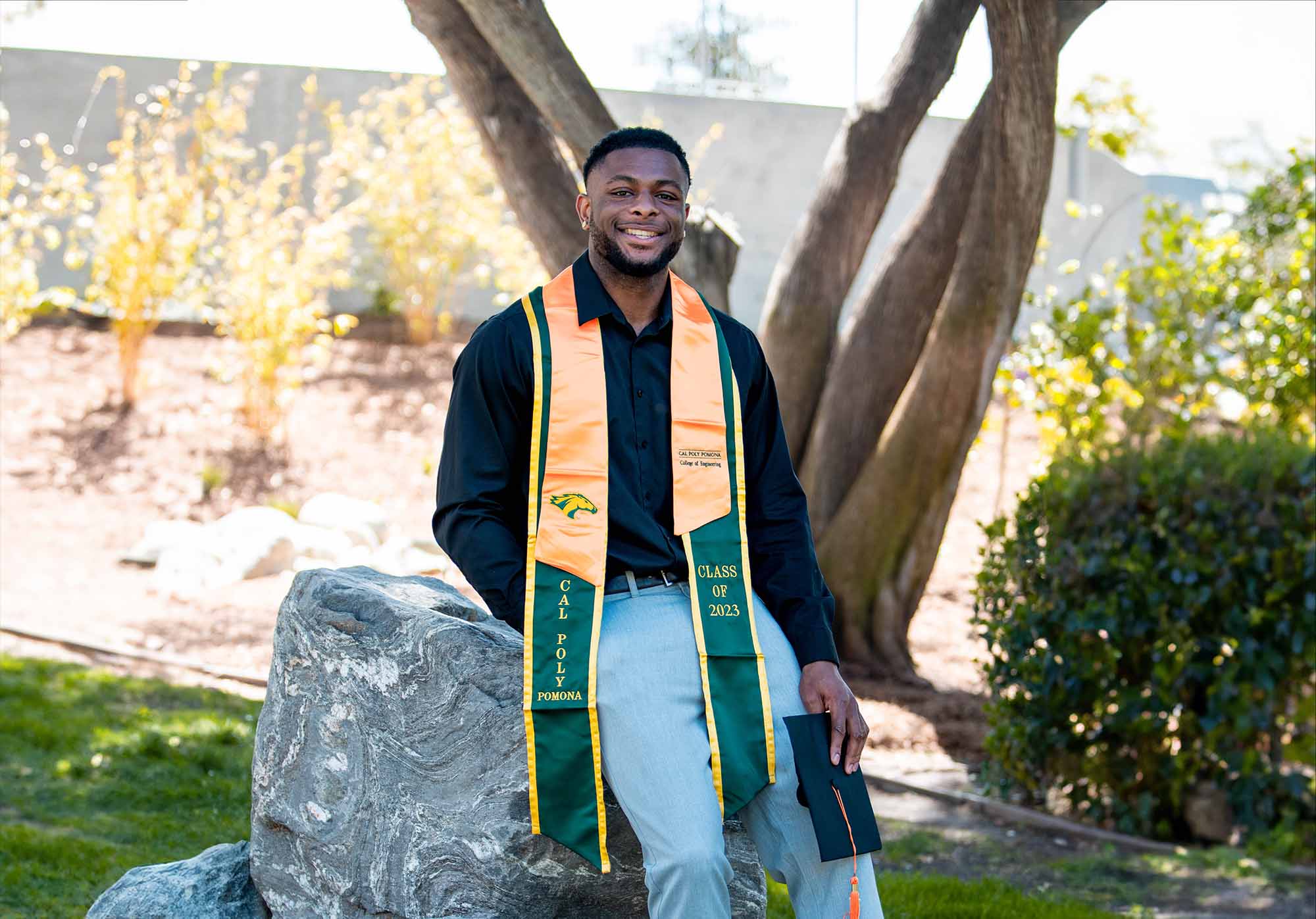 student posing in graduation attire