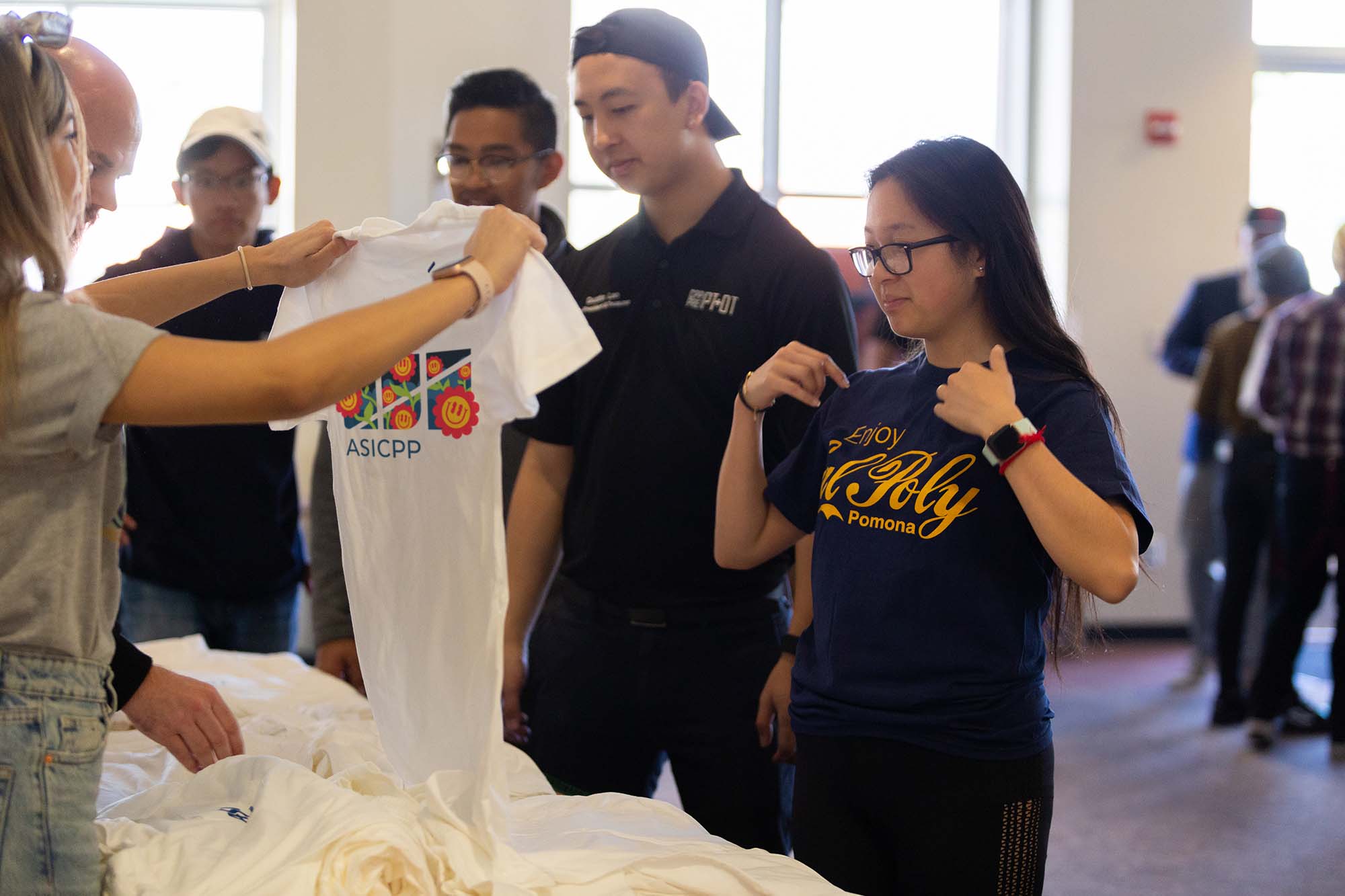 staff handing out t-shirts to students