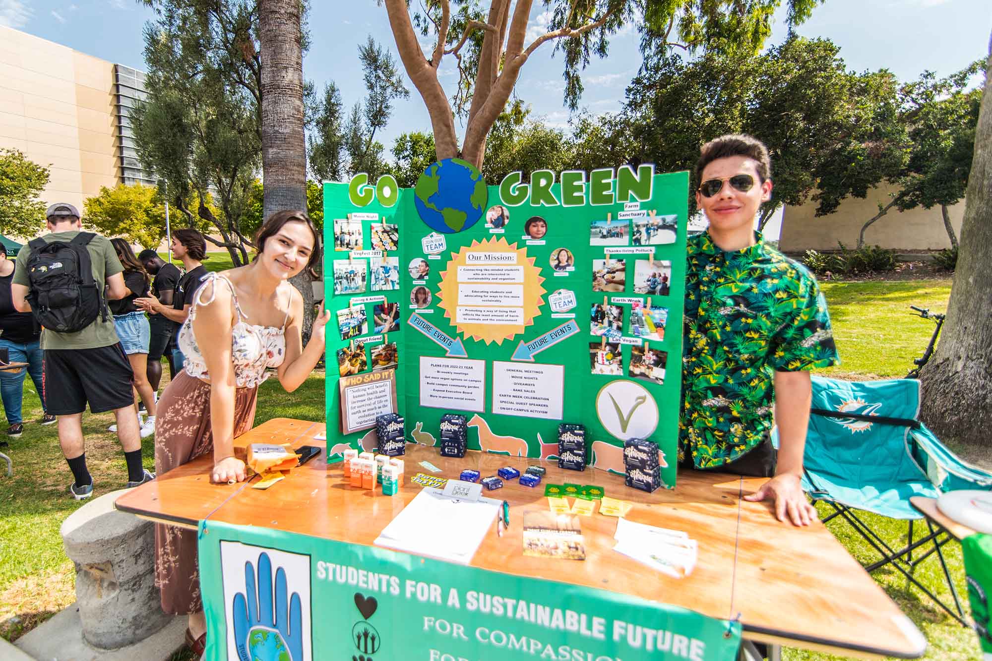 Sustainability club members showing a poster board with club info