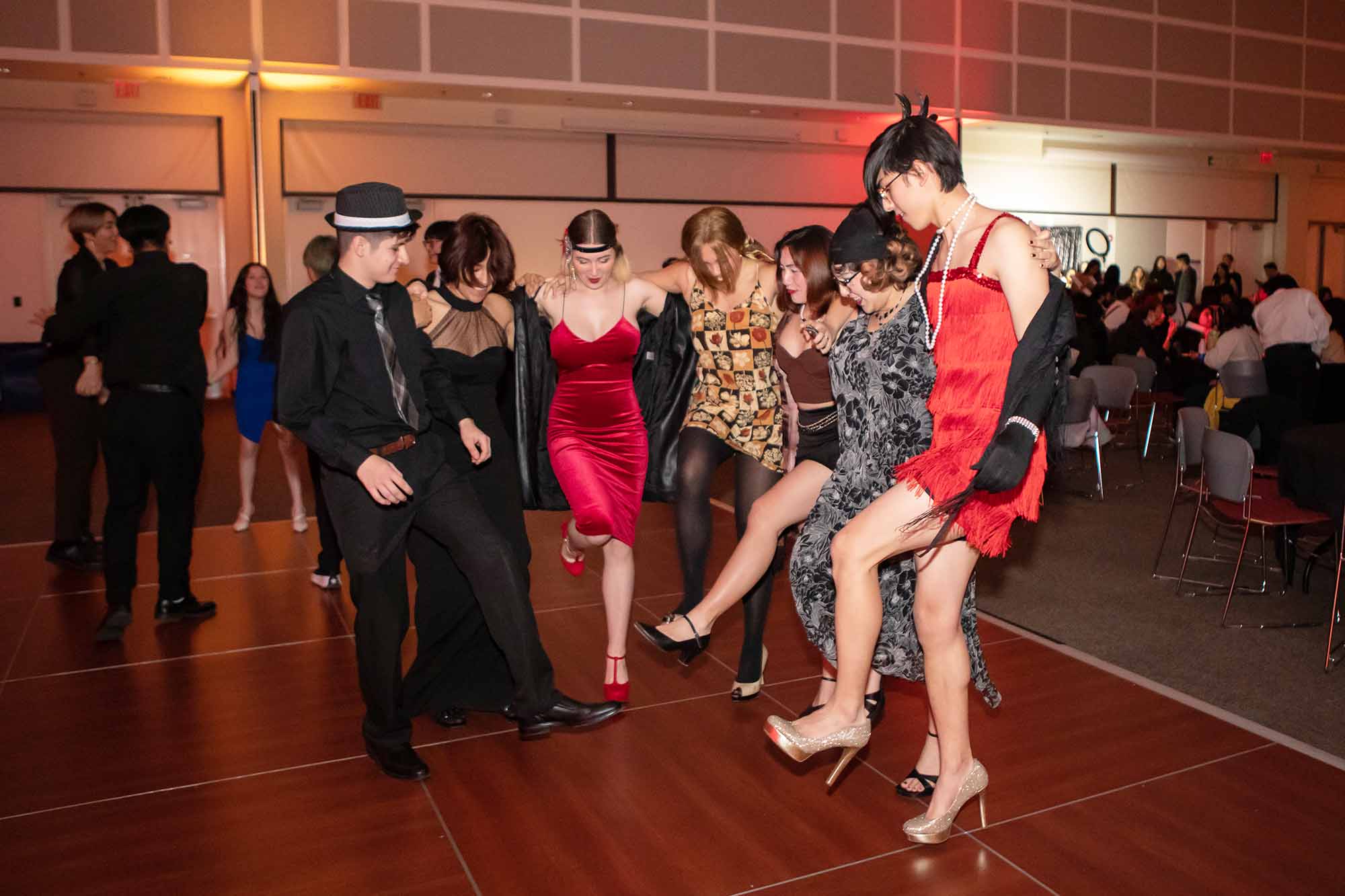 People in semi-formal 1920s attire dancing at an indoor event