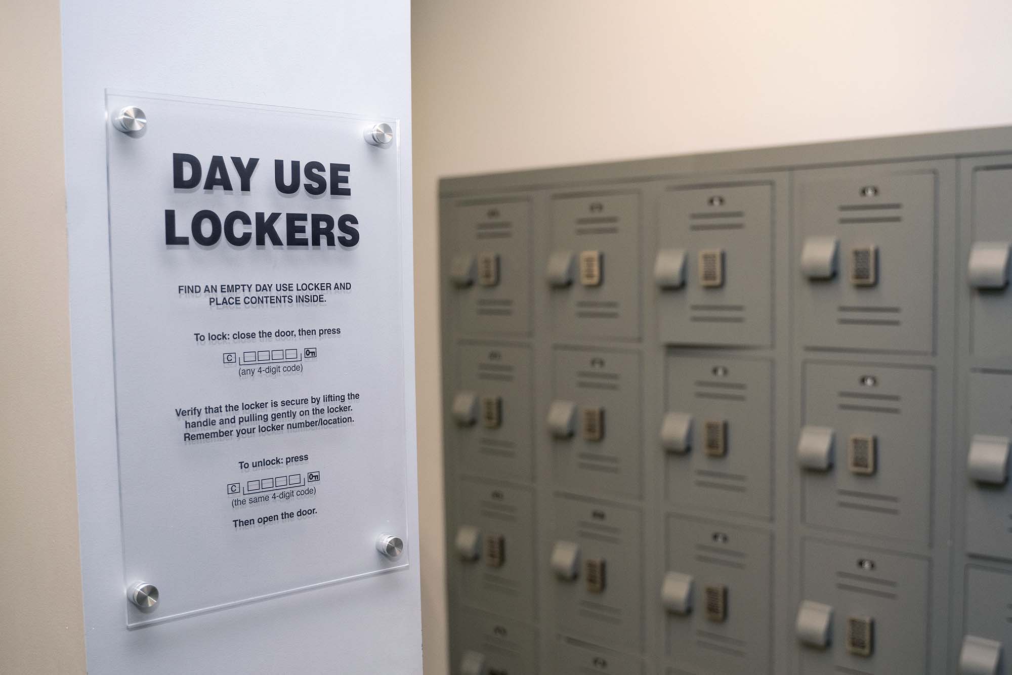 Day use locker instructional signage on a wall