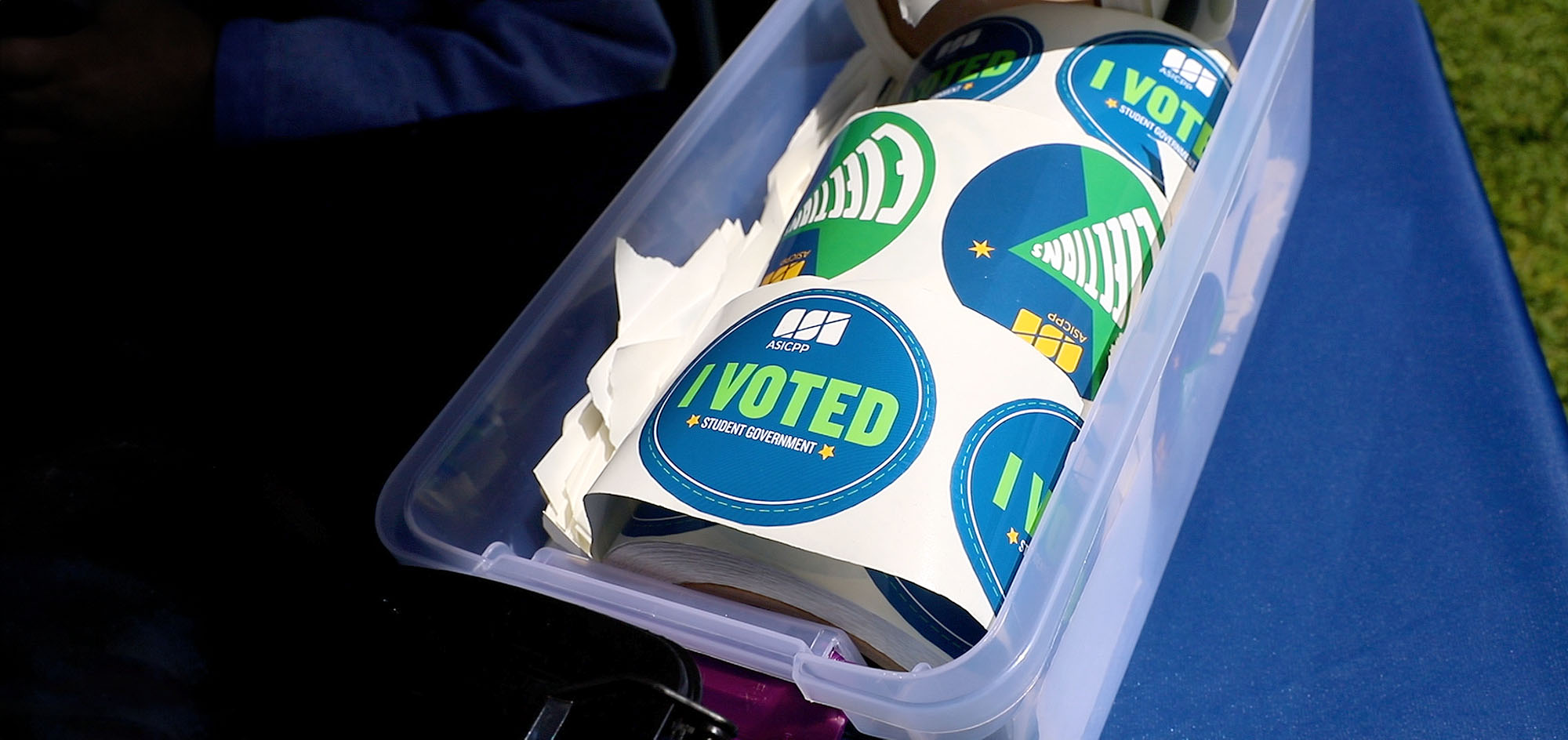 I voted stickers in a plastic bin