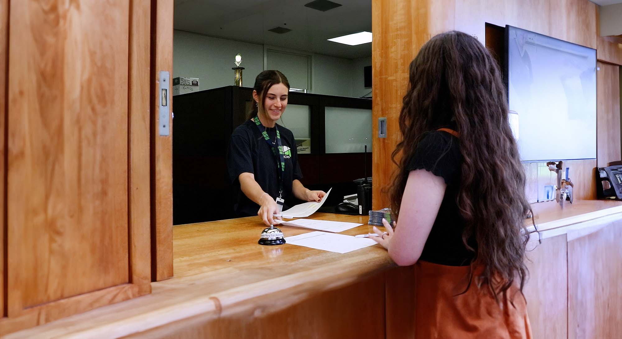Staff member assisting a student at the Financial Services window