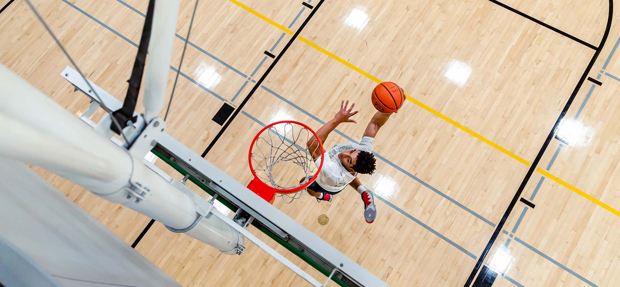Overhead view of person dunking a basketball in the net