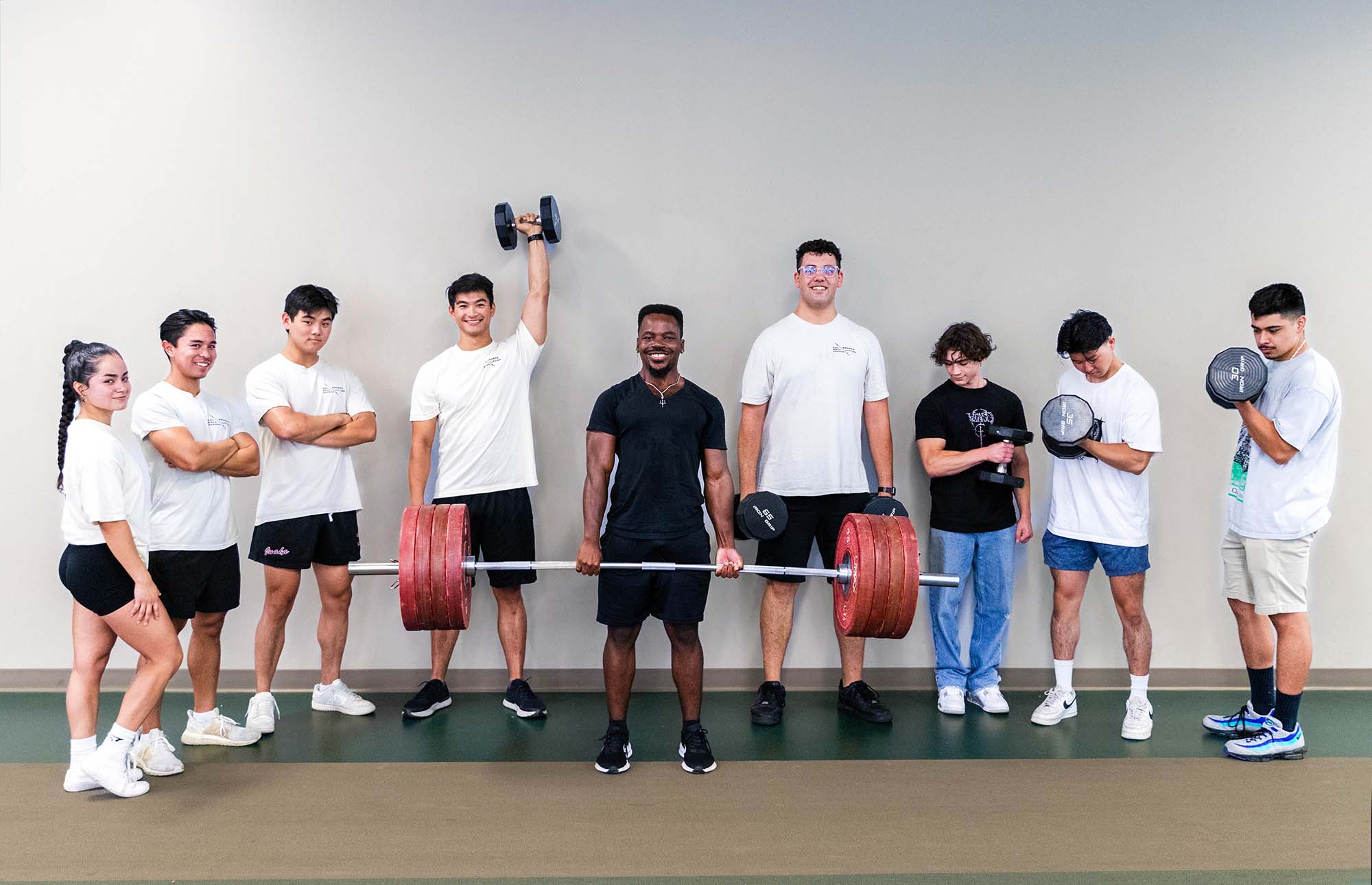 weightlifting club standing in a line smiling