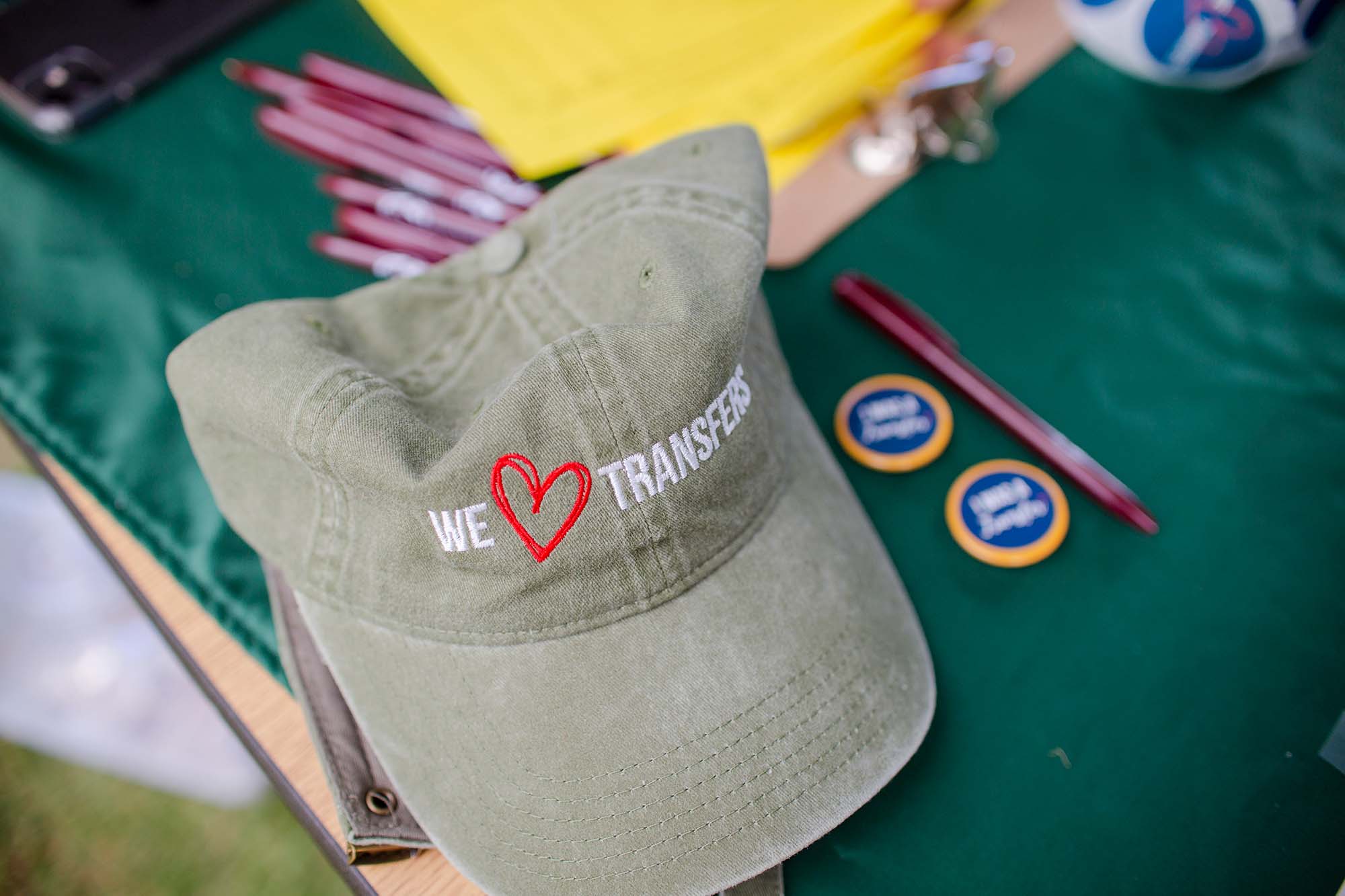 We heart transfer baseball hat on a merchandise table