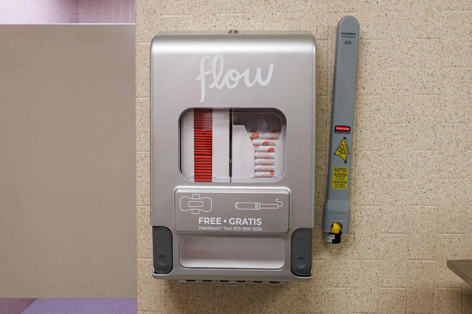Flow menstrual product dispenser on a bathroom wall