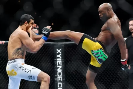 Anderson “The Spider” Silva (right) landing a front kick on Vitor “The Phenom” Belfort (left) at UFC 126)