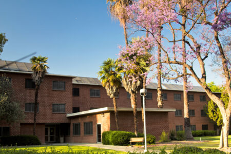 (Alt Text: Outdoor view of a Traditional Hall building at Cal Poly Pomona) 